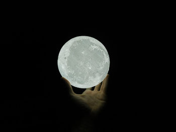 Close-up of person hand against black background