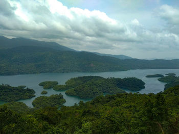 Scenic view of lake and mountains against sky