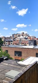 Buildings in town against sky