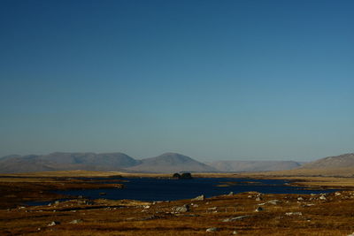 Scenic view of mountains against clear blue sky