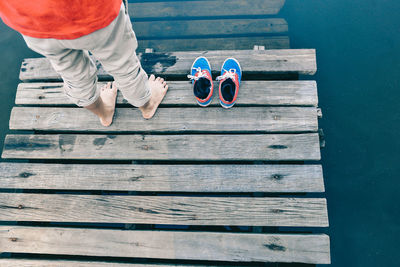 Low section of person standing on pier