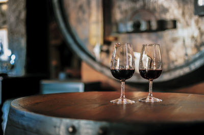 Close-up of alcoholic drinks served on wooden table in restaurant