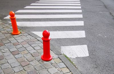 High angle view of red crossing sign on road