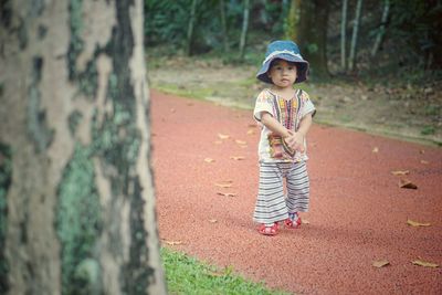 Portrait of cute girl walking on footpath