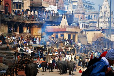 People on street against buildings in city