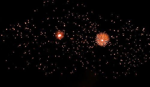 Low angle view of firework display at night