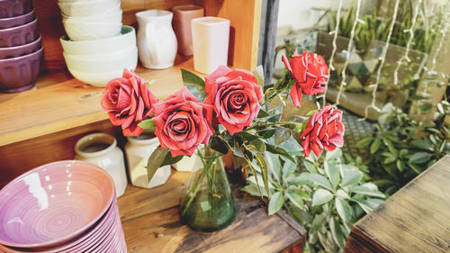 Close-up of roses in vase on table