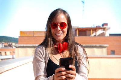 Portrait of young woman using mobile phone