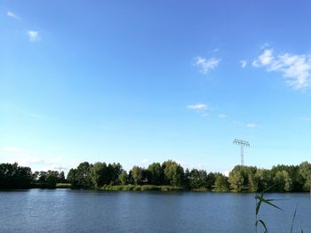 Scenic view of lake against blue sky