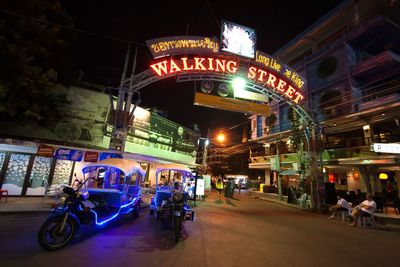 View of illuminated city street at night