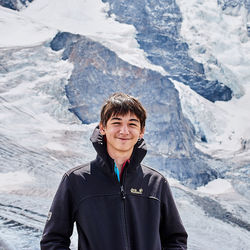 Portrait of smiling boy standing on mountain