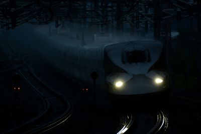 Tokaido shinkansen n700a passing through maibara station at rainy twilight time