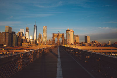 Bridge in city against sky