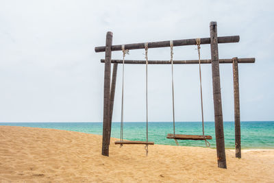 Lifeguard hut on beach against sky