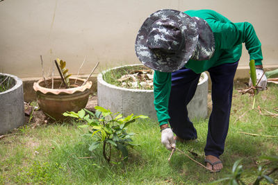 Full length of gardener working in garden