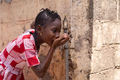 Portrait of woman against wall