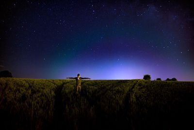 Scenic view of field against clear sky at night