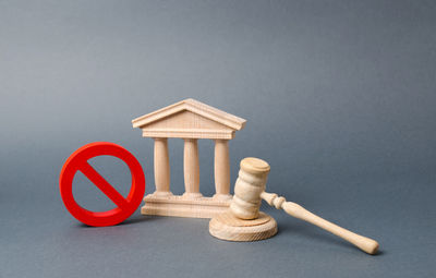 Government or bank building and a red no symbol with a judge gavel. declaration of default 