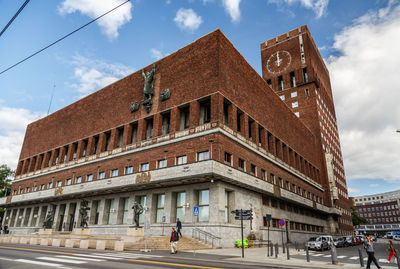 Building by road against sky in city