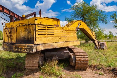 Abandoned truck on field against sky