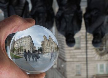Low section of man holding crystal ball