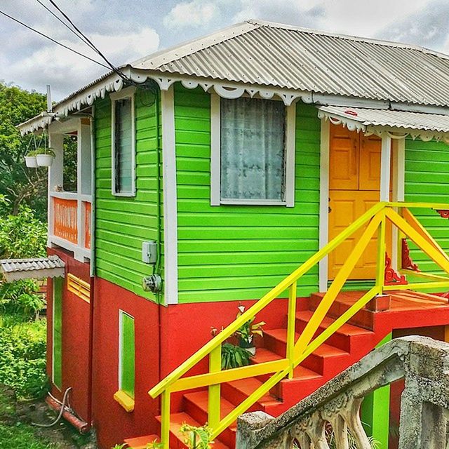 architecture, built structure, building exterior, sky, house, cloud - sky, cloud, grass, window, green color, yellow, day, blue, no people, outdoors, closed, railing, residential structure, multi colored, fence