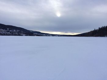 Scenic view of frozen landscape against sky