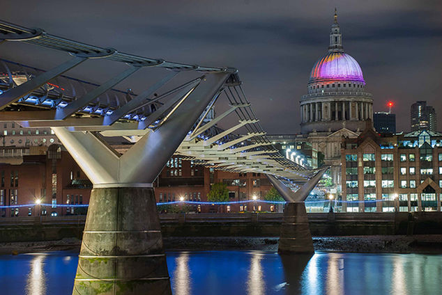 VIEW OF ILLUMINATED BRIDGE OVER WATER AT NIGHT