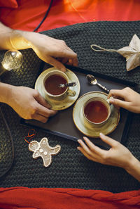 High angle view of woman holding coffee cup