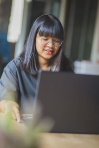 Teenager girl using laptop at home