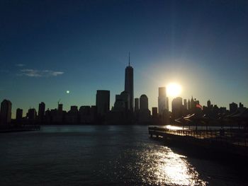 Hudson river by one world trade center against bright sky