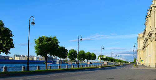 Street by road against clear blue sky