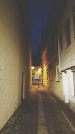 Narrow alley in city at night