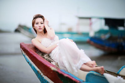 Portrait of young woman sitting on boat