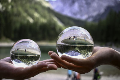 Cropped image of person holding crystal ball