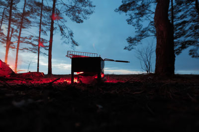 Built structure on field against sky at sunset