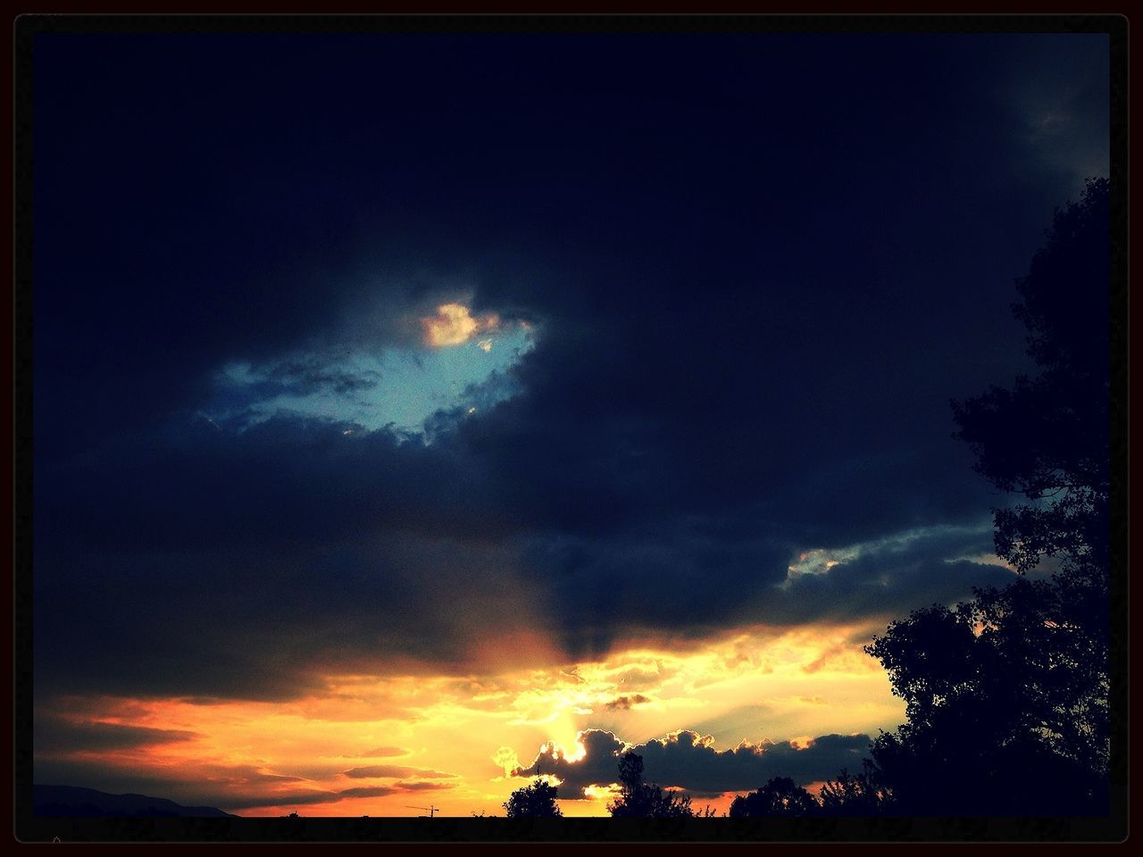 sky, silhouette, sunset, transfer print, tree, low angle view, beauty in nature, cloud - sky, scenics, auto post production filter, tranquility, tranquil scene, nature, cloud, dusk, outdoors, idyllic, blue, no people, cloudy