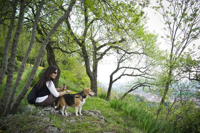 Woman with his dog in the wild, admiring the view