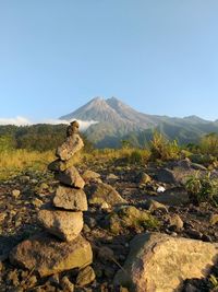 Stack of rocks on mountain against sky