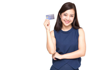 Portrait of a smiling young woman against white background