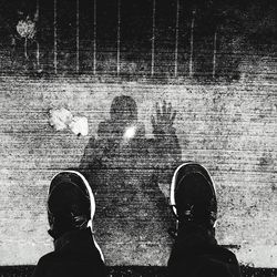 Low section of man standing on tiled floor