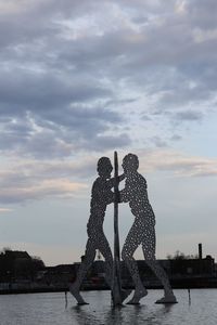 Sculpture by sea against sky in city