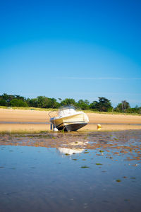 A motorboat laying on plage de la loge at lowtide on a sunny summertime on the isle of île de re