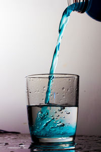 Close-up of water splashing in glass