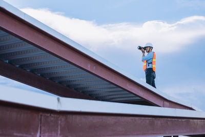 Low angle view of man standing against sky