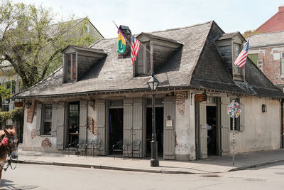 Exterior of old building by street against sky