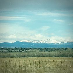 Scenic view of landscape against cloudy sky