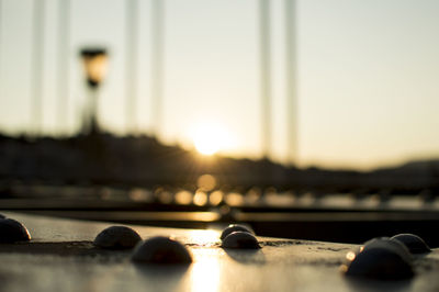 Surface level of sea against sunset sky