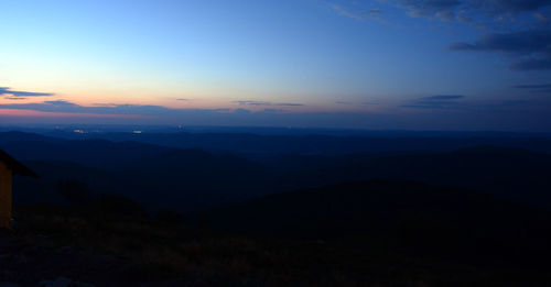 Scenic view of silhouette mountains against sky during sunset