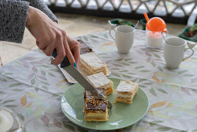 Midsection of woman having food on table